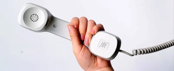 hand holding phone for first sales call