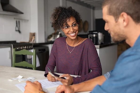 A business owner uses a calculator to find the total revenue