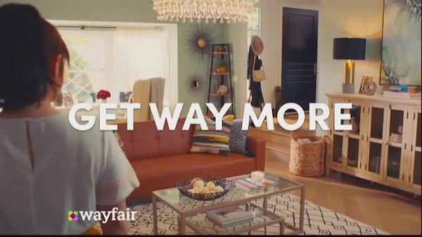 Wayfair TV programmatic ad on TV. A woman stands in a furnished room with the overlaid text: "GET WAY MORE"