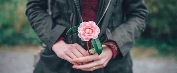 ways to thank a coworker: image shows person holding a flower