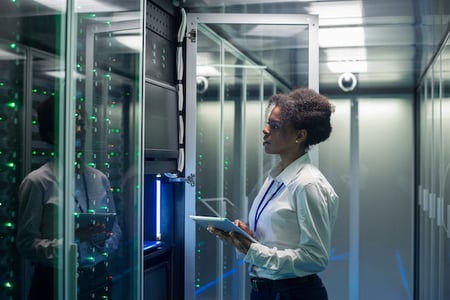 data warehouse worker inspecting a server room