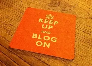 what is business blogging: image shows coaster with words 'keep up and blog on'