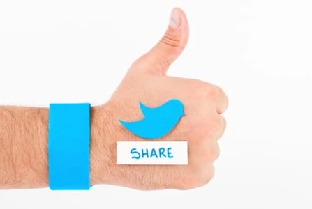 hand giving thumbs up with twitter logo and share button