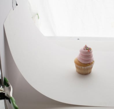 White sweep behind cupcake product photo