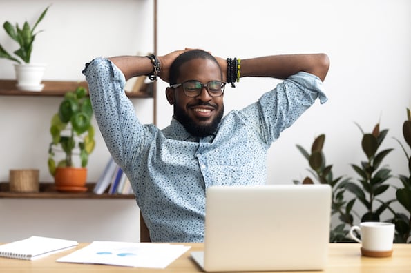 man using a laptop to install a wordpress testimonial plugin