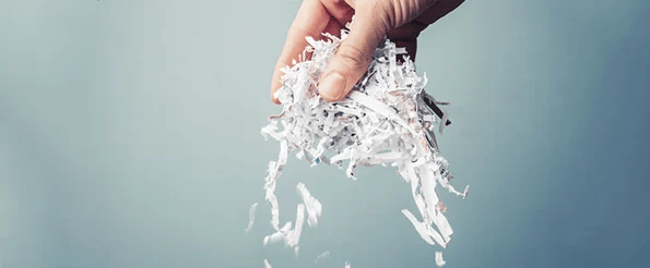 hand holding shredded paper