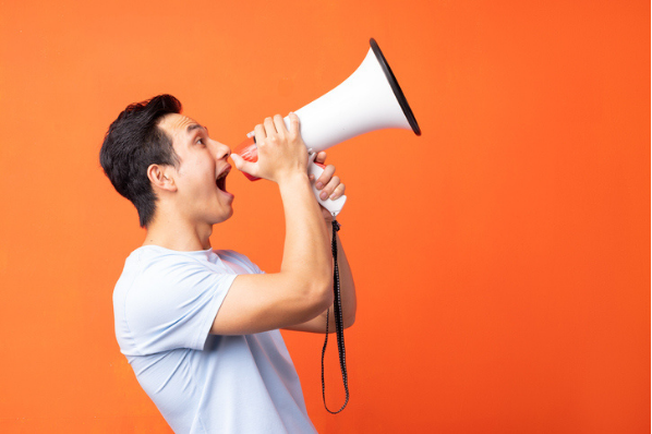 Marketer using a megaphone to announce a company slogan and tagline