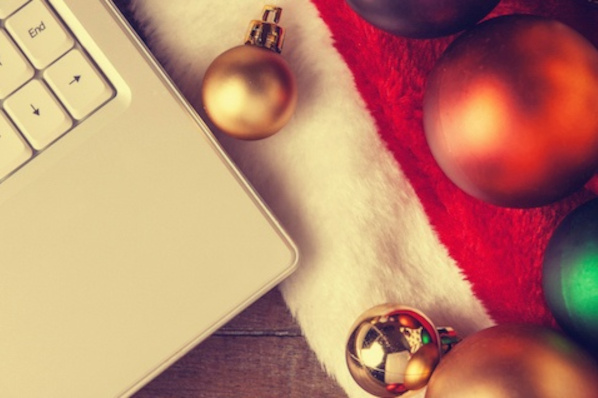 holiday marketing campaign concept featuring a computer next to a santa hat and ornaments
