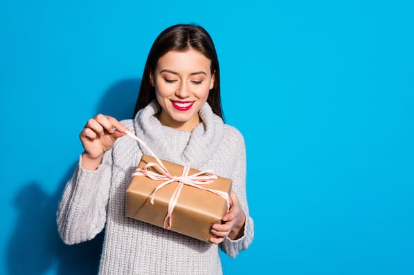 Consumer opens up gift during holiday season