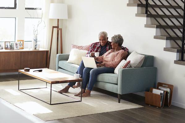 two people sitting on a couch in a living room installing a wordpress plugin