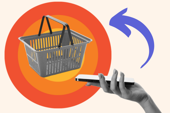 A hand holds a smartphone in front of a shopping cart